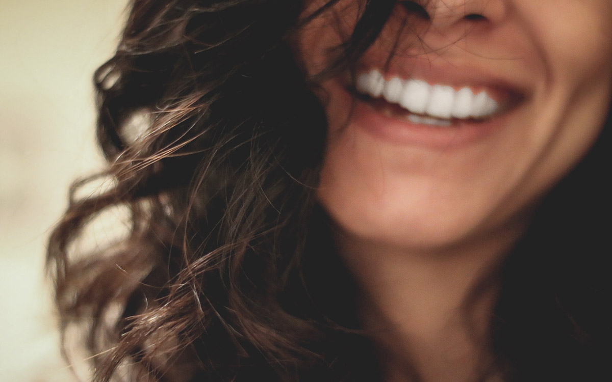 Smiling woman's lower face and long hair